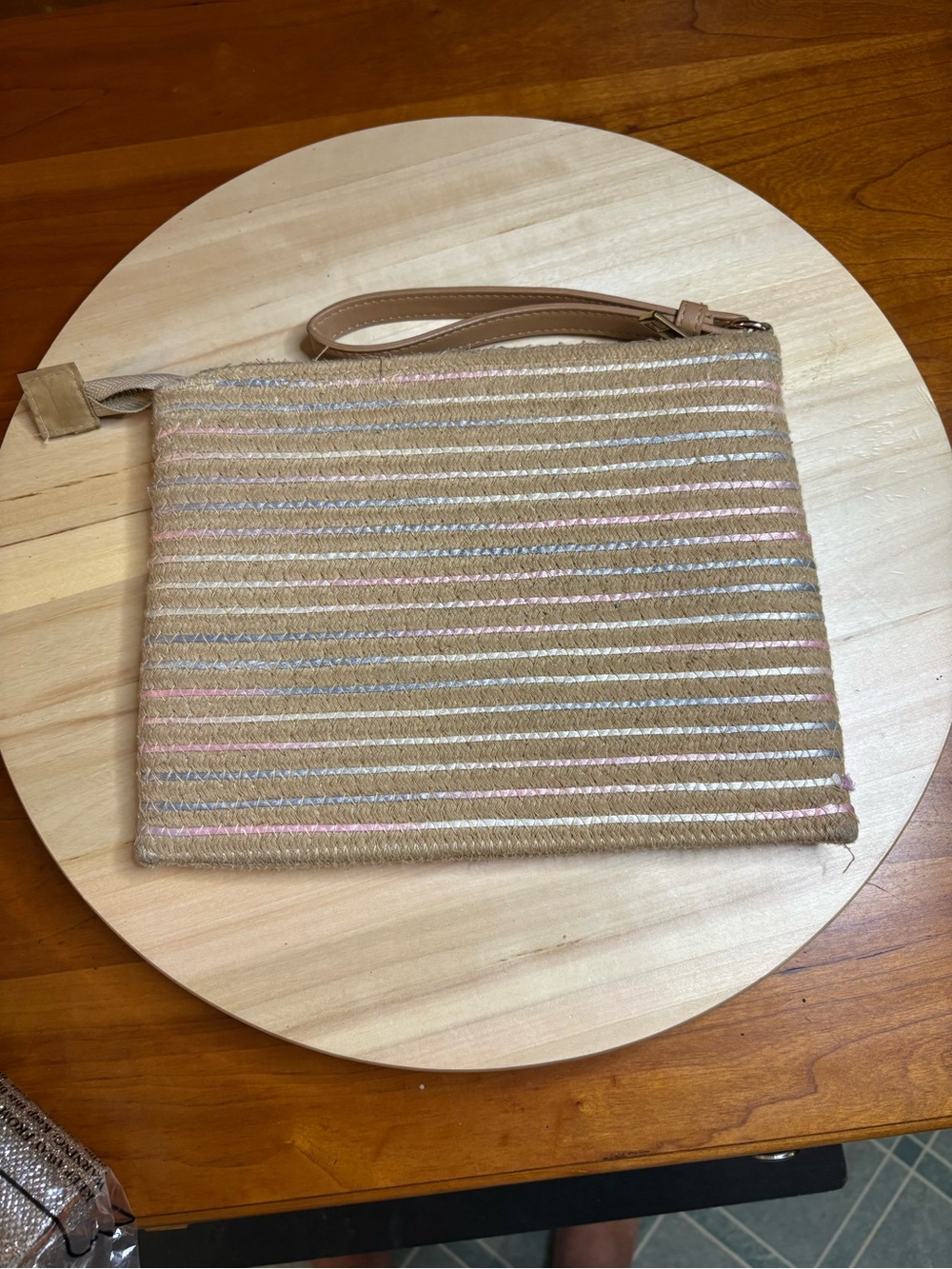 corded wristlet clutch purse featuring a multicolor thin stripe design.